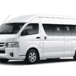 Toyota Hiace Commuter putih tampak serong depan dan samping untuk layanan sewa Hiace Jakarta dengan driver profesional