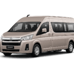Toyota Hiace Premio coklat muda metallic tampak serong depan dan samping untuk layanan sewa Hiace Jakarta dengan driver profesional